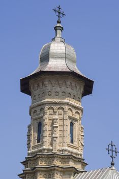 Church bell tower of Dragomirna Monastery, close-up image. The sculptures decorating the tower made in stone, part of Unesco heritage