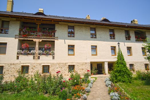 Flower garden and traditional orthodox monastery in Bucovina, Dragomirna Monastery