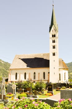View of a church and chapel typical of the Austrian Tyrol with a small garden