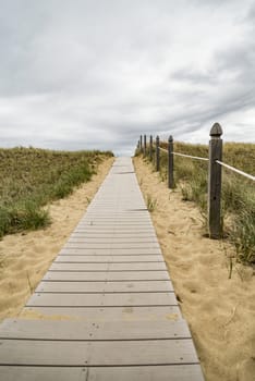 Wooden path over dunes at beach. South of Maine, USA