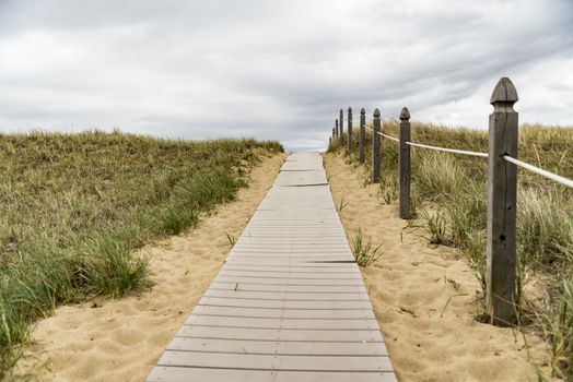 Wooden path over dunes at beach. South of Maine, USA