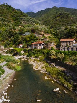 Photo of the stone bridge and river in the small old town of Badalucco in Italy in the province of Imperia, the Italian region Liguria.