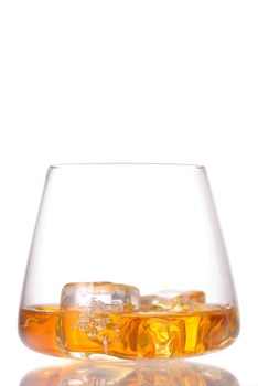 Glass of scotch whiskey and ice isolated on white