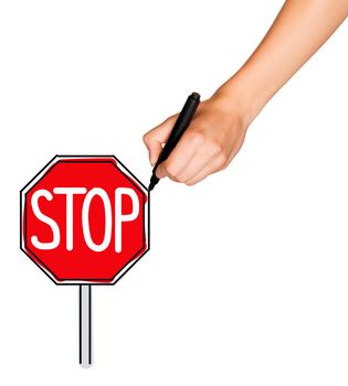 A female hand holds black marker and draws red stop sign. Isolated on white background