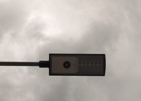 a street lamp as seen from underneath with cloudy background; UK