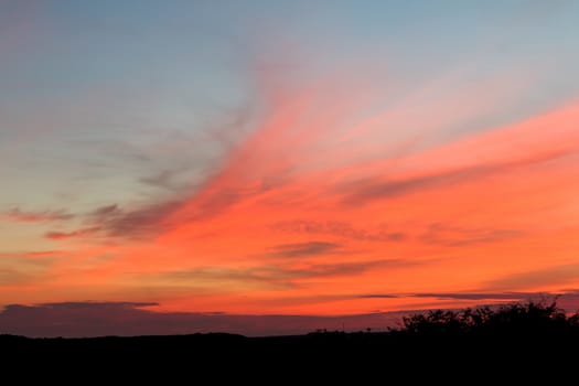 Pink and orange clouds across sky in East Sussex, England.