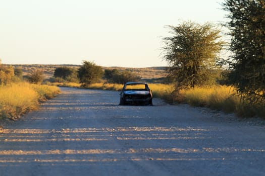 A burned car along the road inside Kgalgadi National park, South Africa