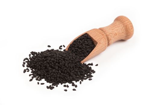 Black cumin seed in wooden scoop isolated on white background, Nigella sativa