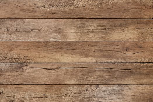 Old weathered wood surface with long boards lined up. Wooden planks on a wall or floor with grain and texture. Light neutral tones.