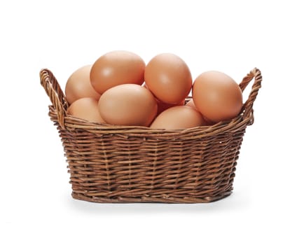 Brown eggs in the basket isolated on white background.