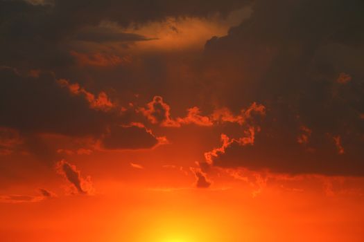 Thunderclouds at sunset. Gloomy dark gray clouds. Nature summer sunlight wallpaper