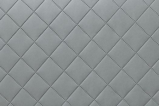 detail of sewn leather, gray leather upholstery background pattern