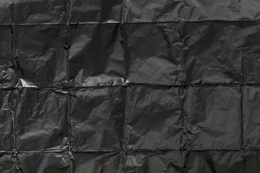 Creased aluminum foil background texture, black texture