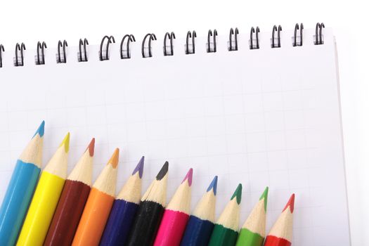 image of a notebooks and Colorful Pencils, close-up