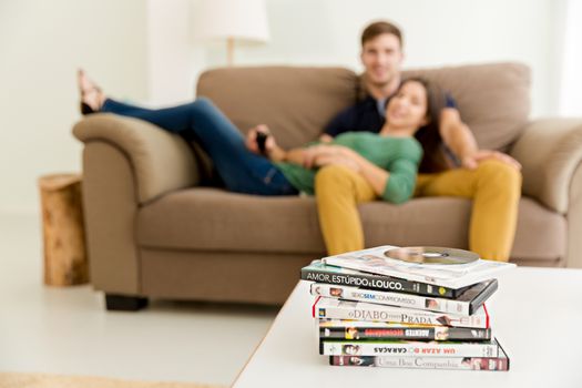 Young couple sitting on the sofa and watching movies