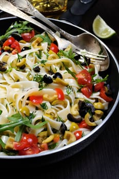 Pasta with crushed olives and cherry tomatoes, arugula. 