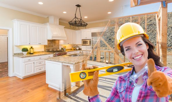 Female Construction Worker In Front of House Framing Gradating to Finished Kitchen Photo.