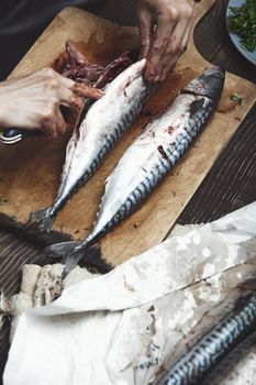 Woman preparing mackerel fish