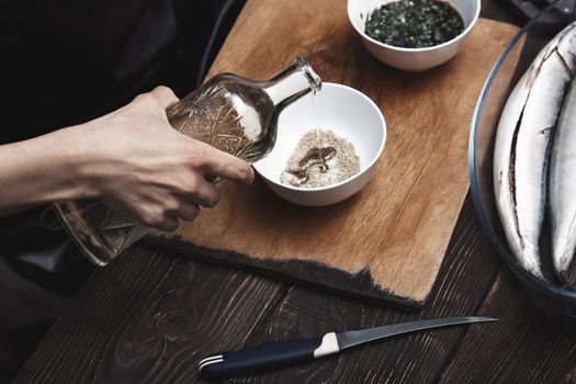 Woman preparing marinade for fish