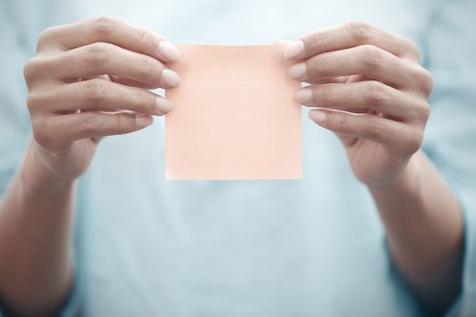 Woman holding adhesive note
