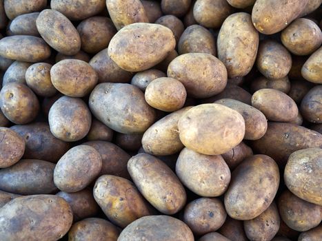 Fresh organic potatoes on display in a store market