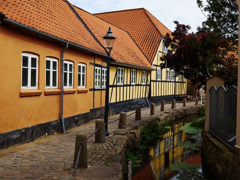 Typical small beautiful street with old traditional Danish style houses Bogense Denmark            