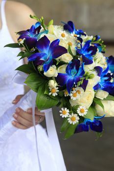 The bride holds a wedding bouquet