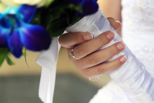 The bride holds a wedding bouquet