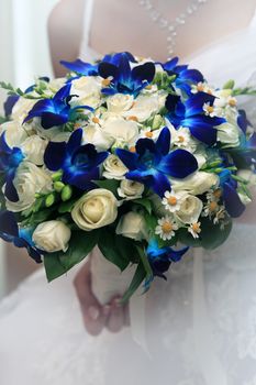 The bride holds a wedding bouquet