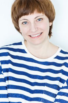 Portrait of smiling woman with short brown hair and blue eyes