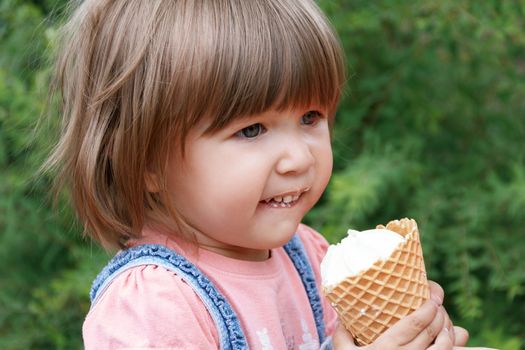 Horizontal photo of cute girl are eating icecream in summer time