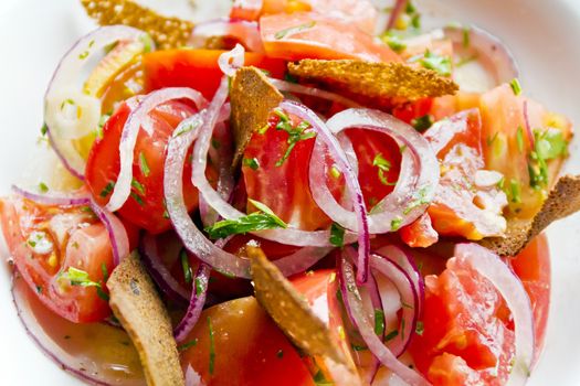 Colorful salad with red tomato onions and bread