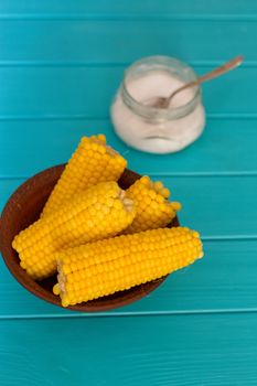 Boiled corn on a blue wood background