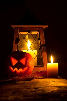 Halloween pumpkin and lantern with candle on black background