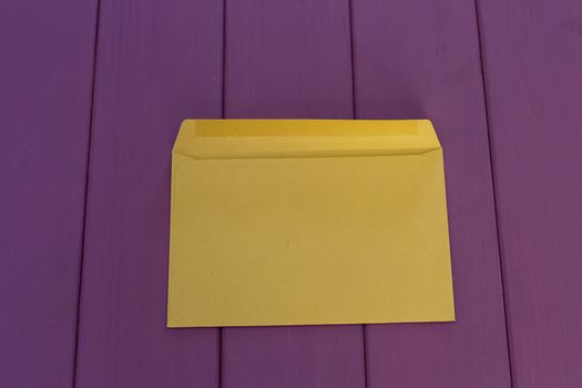 kraft paper envelope on a purple wooden background. Vintage style.