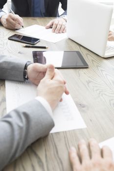 Business people work with documents and computers at office table close up