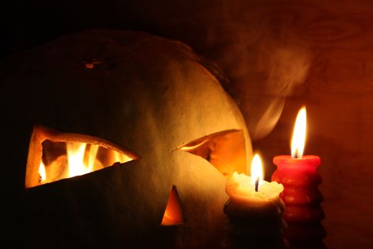 Halloween concept. Fiery pumpkin. Flaming eyes with fire. Scary and scary. Photo horizontal for your design.