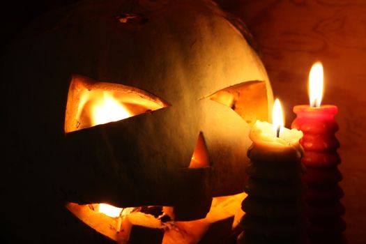 Halloween concept. The pumpkin smiling is burning in the fire. White smoke. Witchcraft and magic. With a burning eye horror. Photo for your design