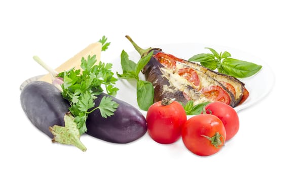 Baked eggplant stuffed with vegetables and cheese decorated with basil leaves on white dish and ingredients for its cooking beside on a white background
