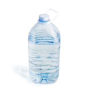 Drinking water in the large transparent plastic bottle with carrying handle on a white background
