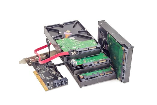 Several SATA hard disk drives, disk array controller card and interface cables on a white background
