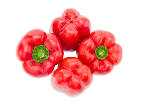 Top view of four fresh red bell peppers on a white background closeup
