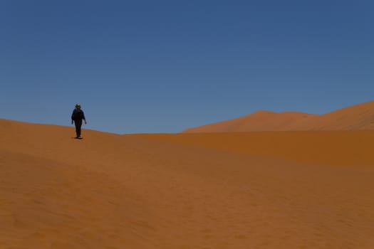 Walking on red dunes from Sossusvlei Namibia