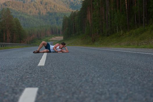 Man laying on the beauty road in mountain