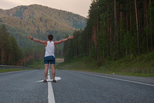 Man laying on the beauty road in mountain