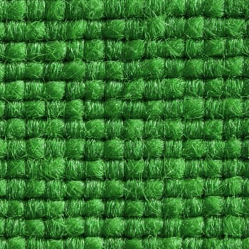 Green fabric with structured and knitted fibres extreme close up.