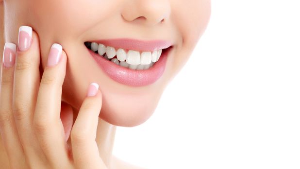 Closeup shot of beautiful female smile, white background.