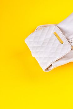 The female white leather backpack on a yellow background