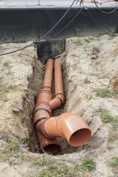 Construction site - orange waste pipe.