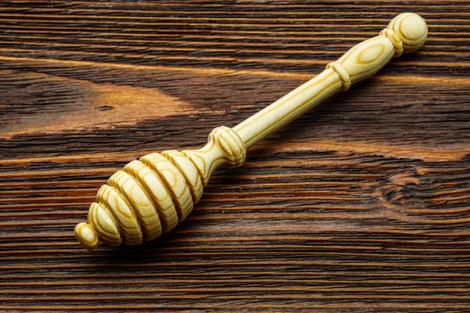 A spoon for honey on an old wooden table